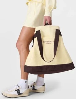 Sweaty Betty SB Canvas Bucket Bag - Buttercream Yellow -The Sports Edit Store sweaty betty sb canvas bucket bag buttercream yellow sb10224 7